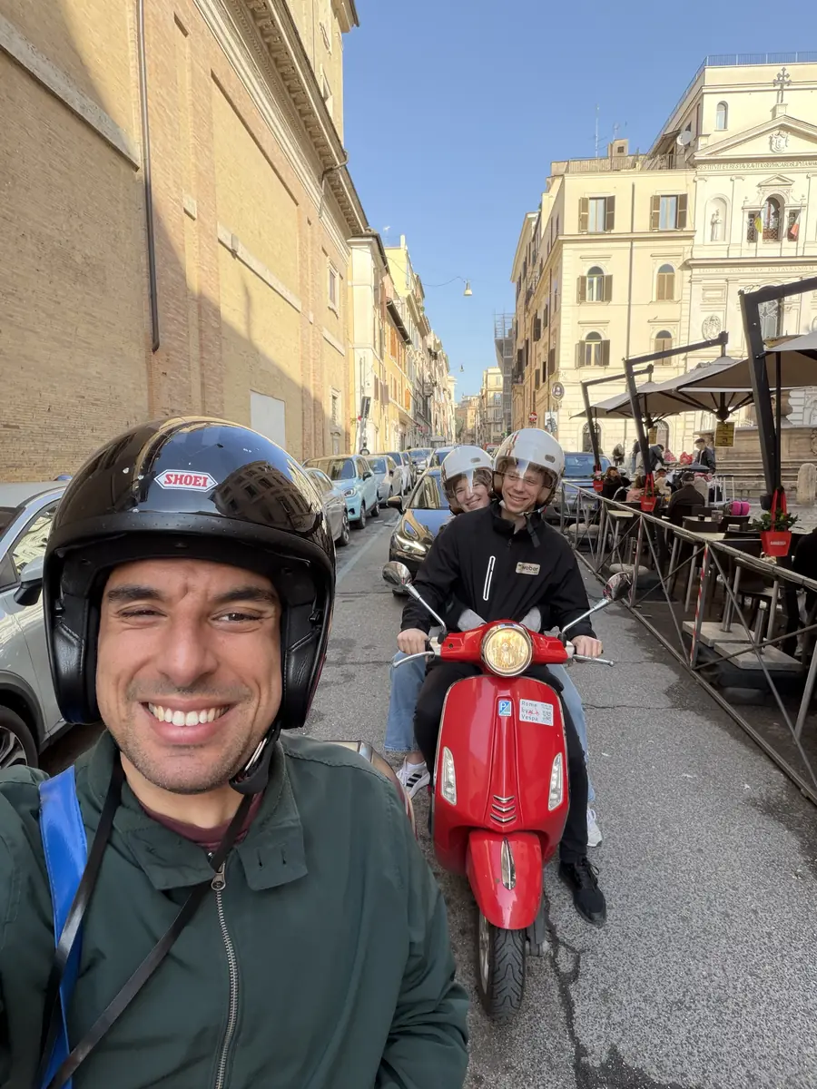 The guide leading two guests through the streets of Rome