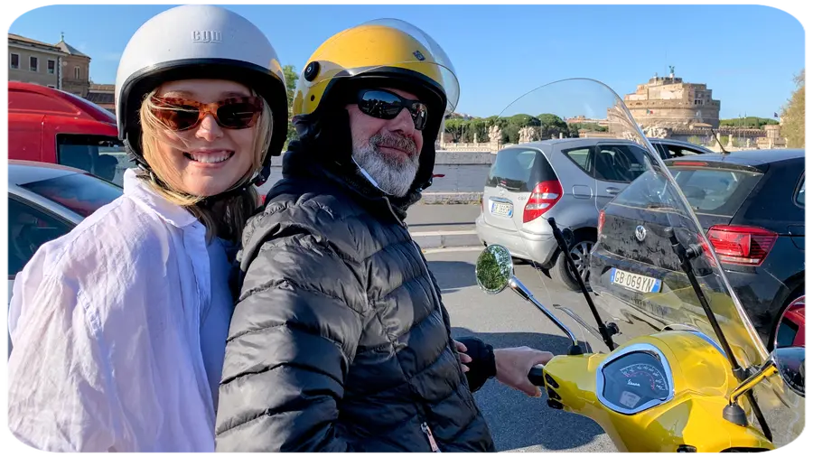 Traveller enjoying a Vespa tour with driver in Rome Traveller enjoying a Vespa tour with driver in Rome